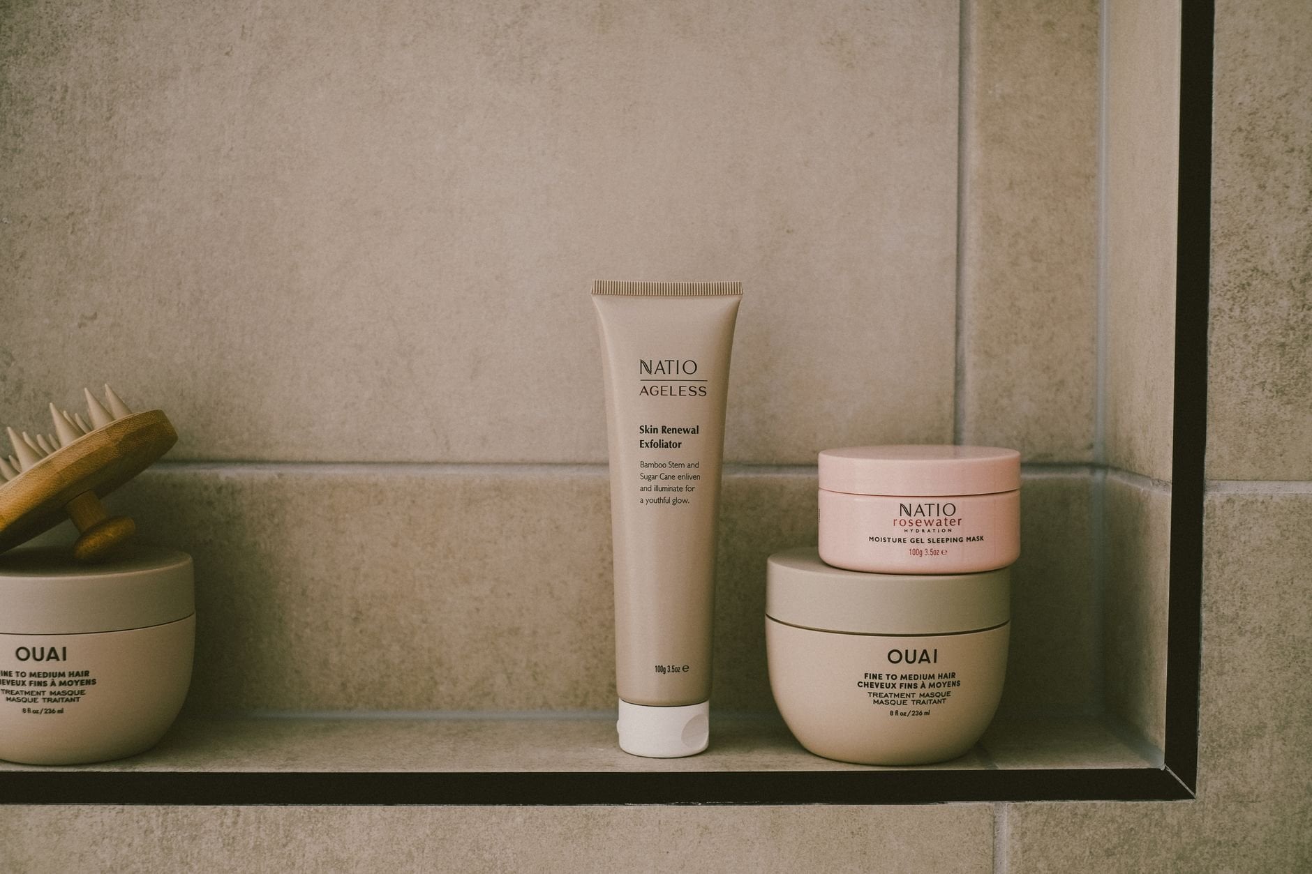 A modern bathroom shelf with self-care products in a minimalist design showcasing beige tones.